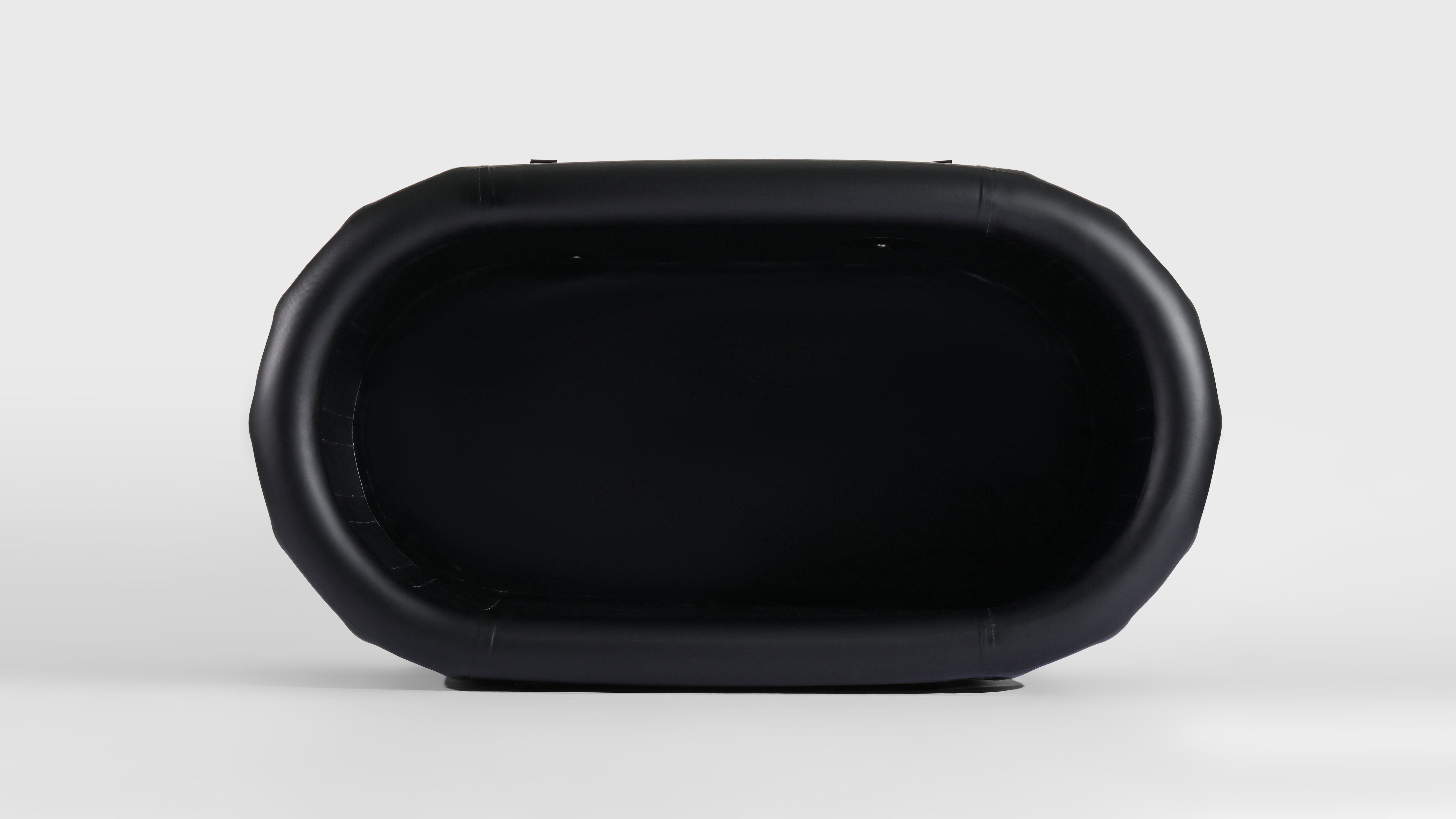 Top view of a compact, black inflatable ice bath tub