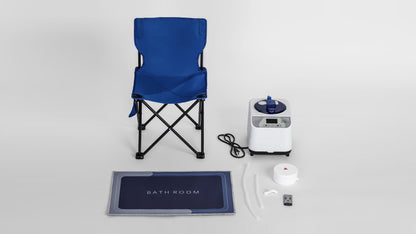 A set of sauna box accessories, including a foldable chair, steam generator, mat, and remote control